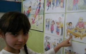 Dziewczynka wskazuje omawianą planszę na tablicy