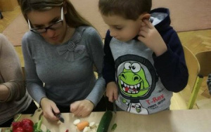 chłopiec z mamą przy stole z warzywami