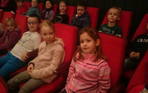 dzieci siedzą na widowni w teatrze