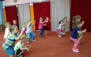 Dzieci radośnie tańczą na dywanie