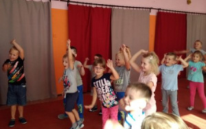 dzieci radośnie tańczą na dywanie