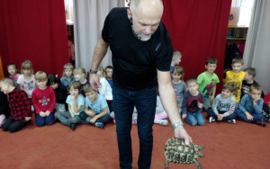 Pan Krystian trzyma w ręce żółwia lądowego greckiego