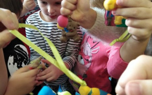 dzieci trzymają w rączkach gipsowe,kolorowe figurki misiów